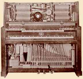 Interior view of the Reproduco "Regular" Pipe Organ showing the twin-roll frames at top and two ranks of pipes below the keyboard.